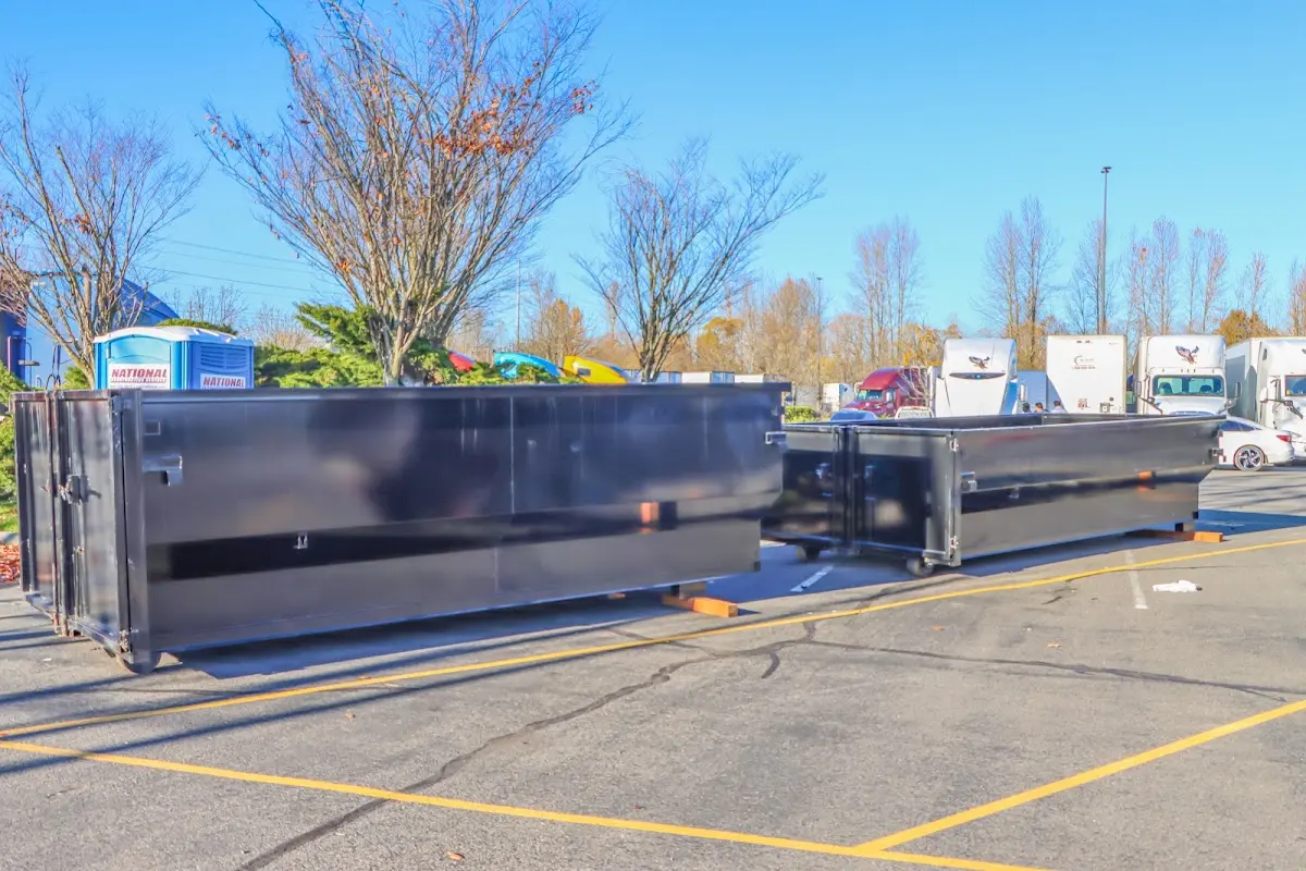 Professional dumpster rental service with roll-off container on residential driveway in West Rockhill